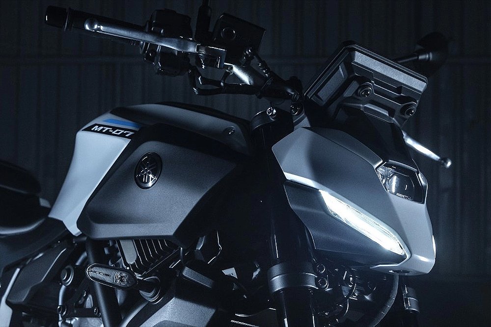 A close-up of the 2025 Yamaha MT-07's triple-LED headlight.