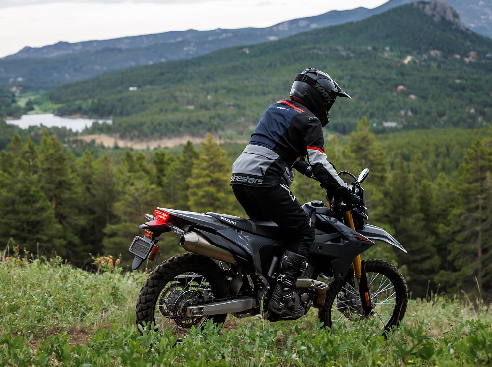 black DR-Z4S on a trail with mountain in the background