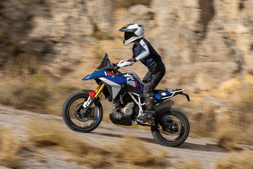 A rider climbs a dirt hill aboard BMW's F 450 GS concept.