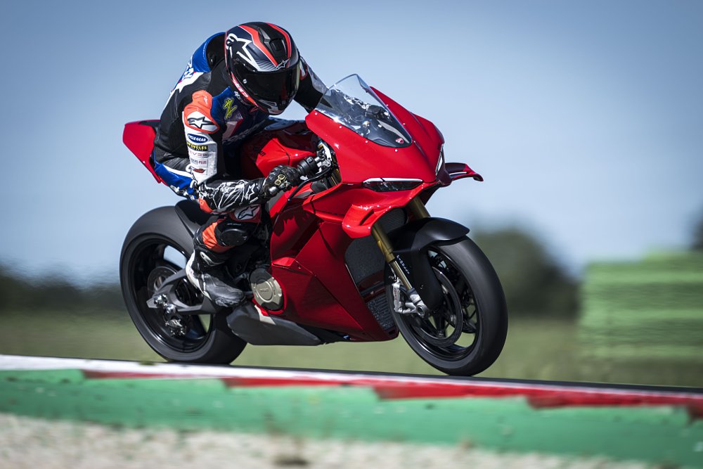 Zack riding a red Ducati Panigale V4 on the race track