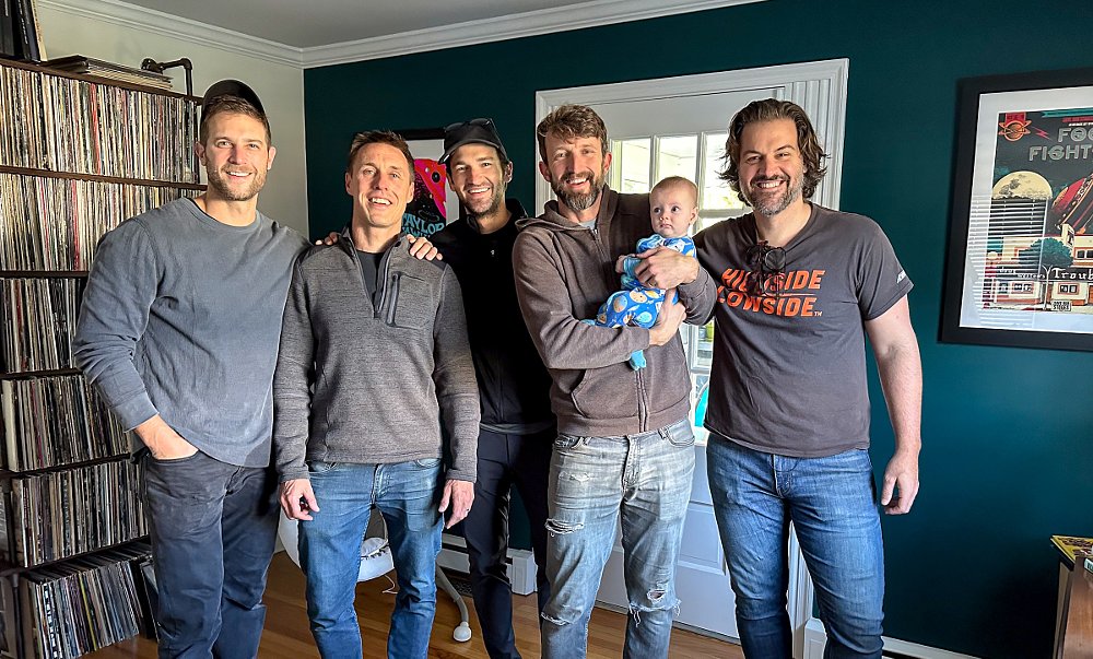 CTXP film team posing with Zack holding baby Spurgeon, who is looking at Zack