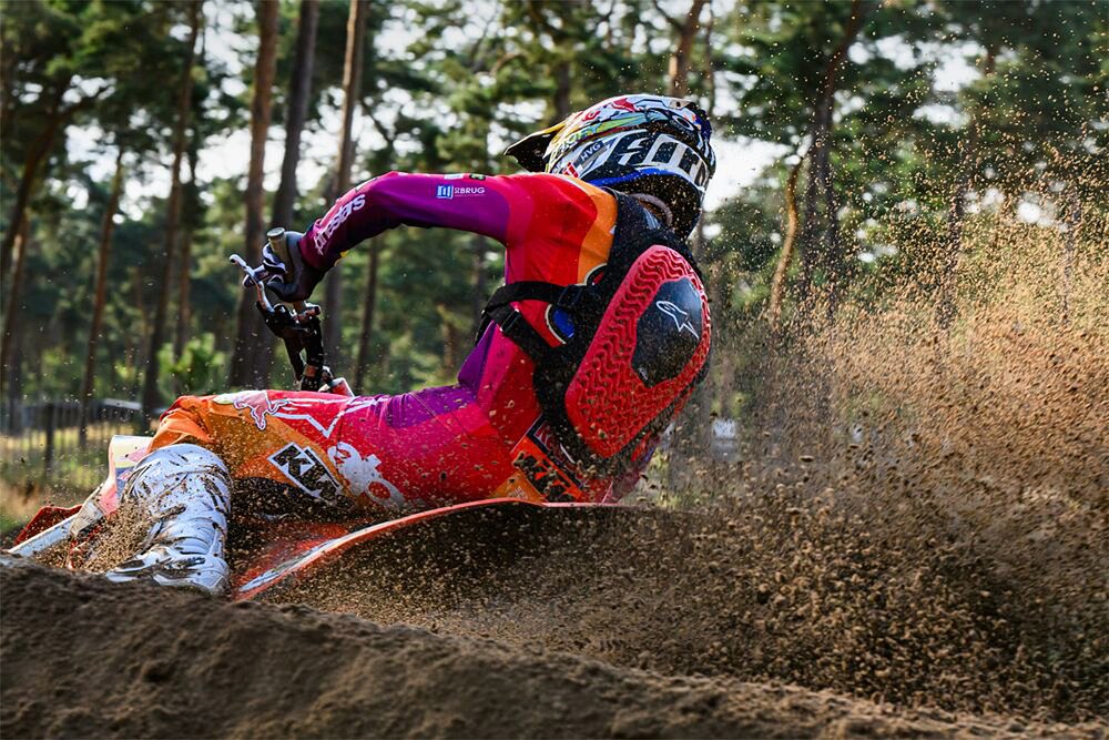 A motocross rider throws roost into the air while wearing Alpinestars' Tech-Air Off Road airbag system.
