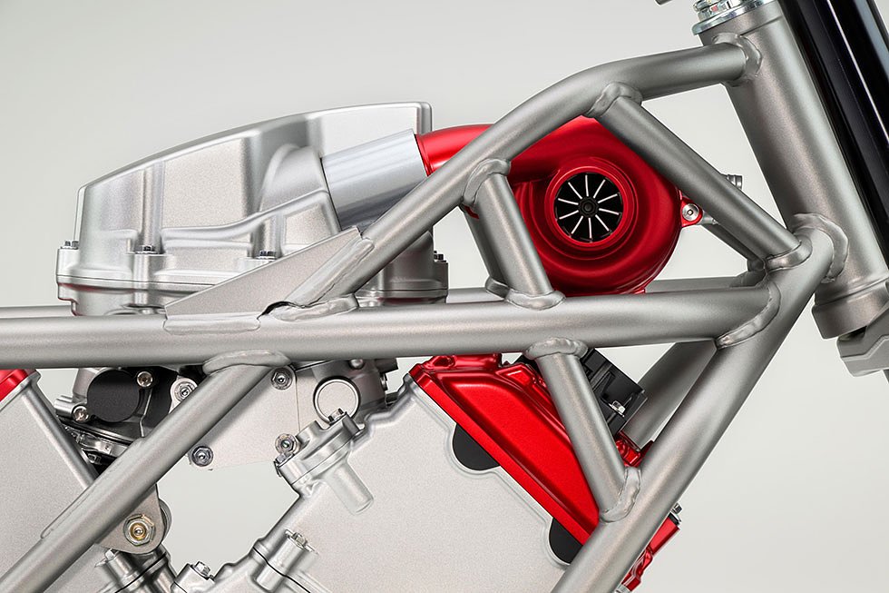 studio photo showing red-painted electric compressor on top of the V-3 engine