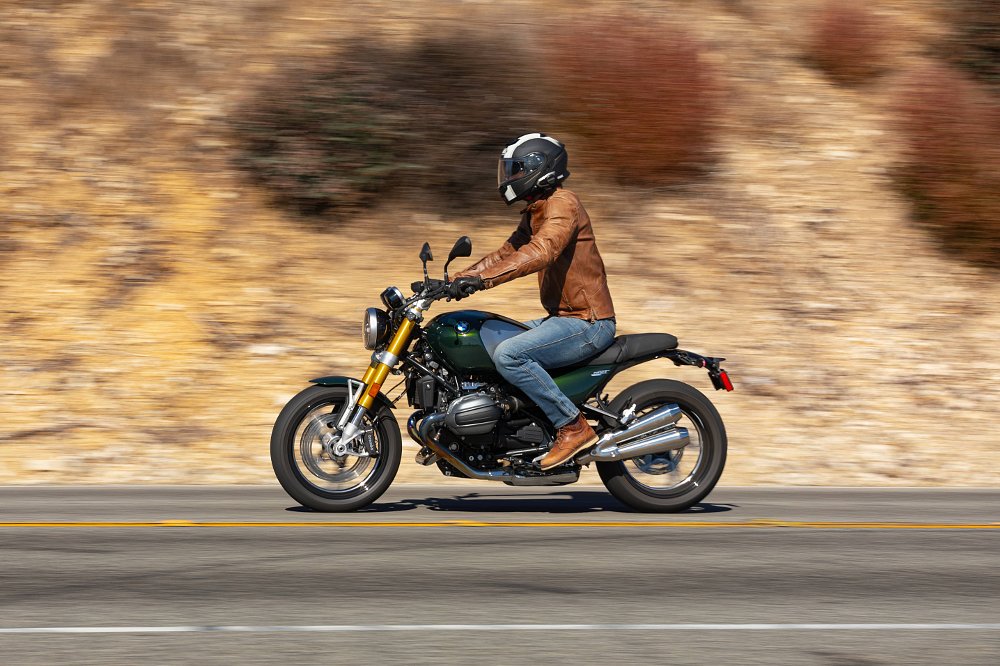 2024 BMW R 12 nineT riding past camera in profile.