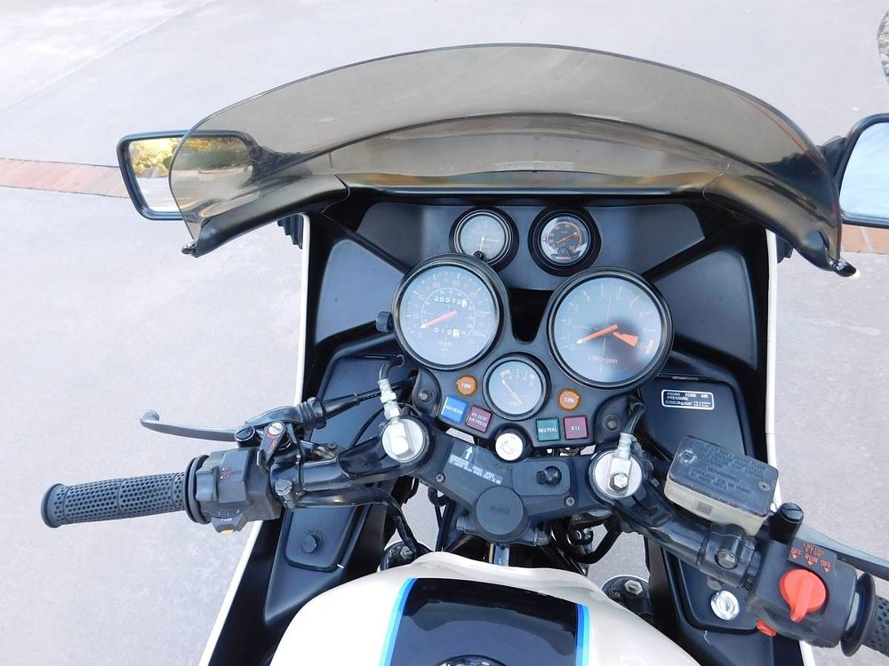 rider's view of the cockpit showing multiple round gauges