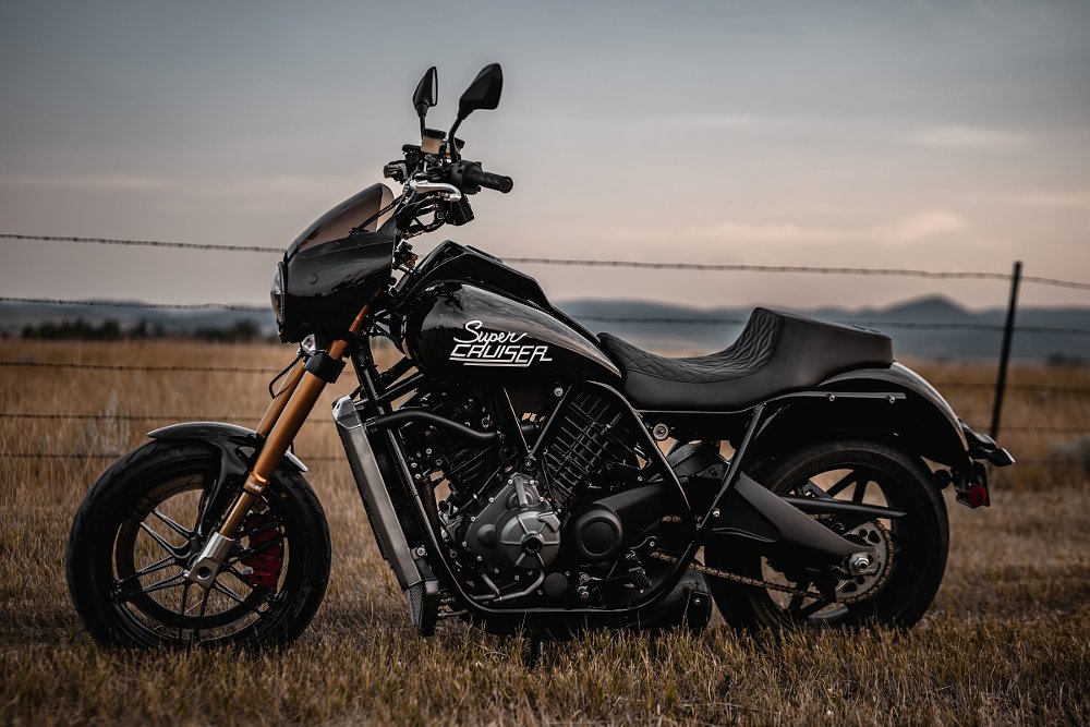 black Buell Super Cruiser parked in a field