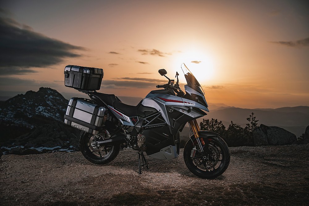Energica Experia motorcycle parked in front of a sunset
