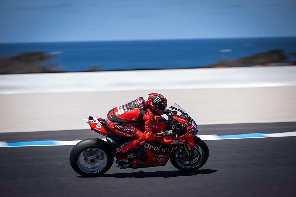 Nicolo Bulega on the track at Phillip Island with the ocean in the background during testing