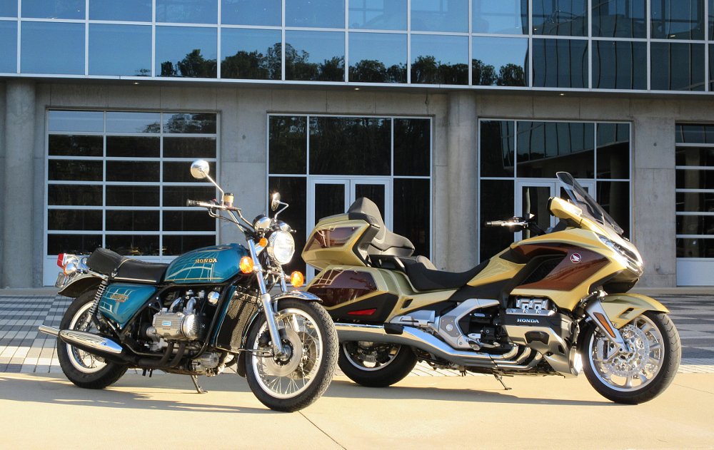 blue 1975 Gold Wing parked next to a larger Eternal Gold 2025 50th Anniversary Gold Wing outside Barber Vintage Motorsports Museum