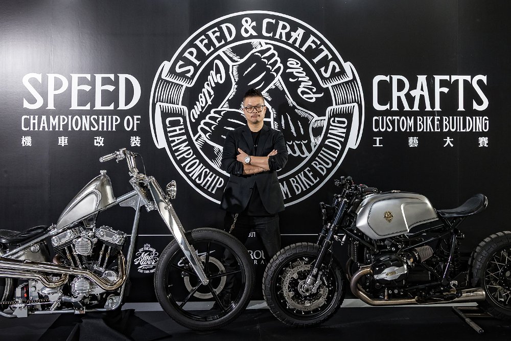 Winston Yeh in front of the show logo