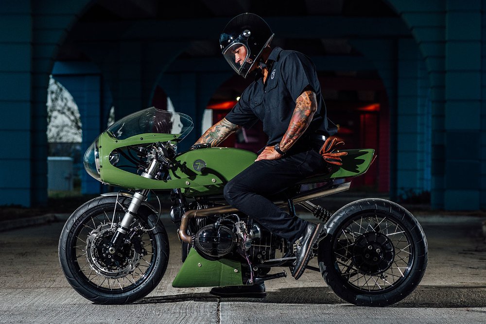 side view of the motorcycle with a rider sitting on it