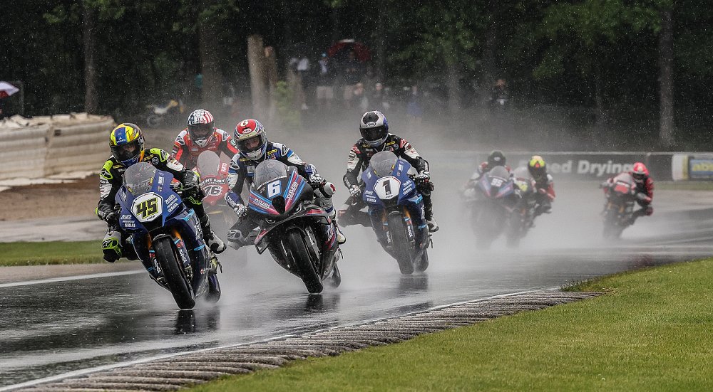 three racers nose to tail in the rain