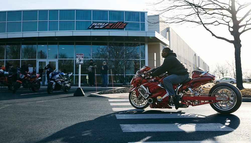 rider on a stretched Hayabusa riding into the RevZilla parking lot for bike night