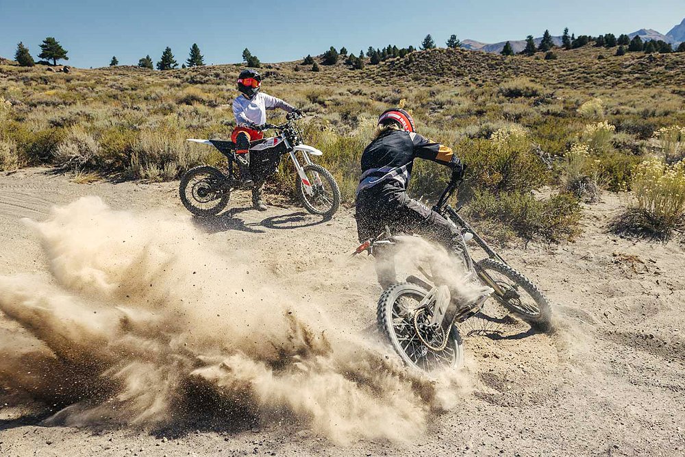Two Zero XB riders take to the trail, with one spinning donuts in the gravel.