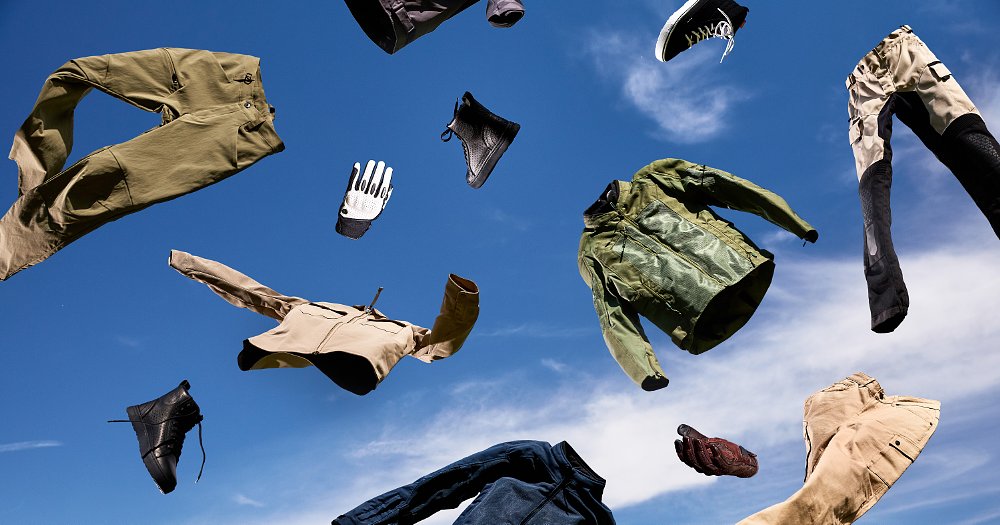Various motorcycle gear items floating before a blue-sky background.