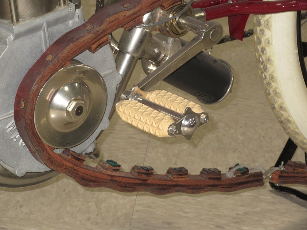 A leather drive belt with leather teeth riveted on