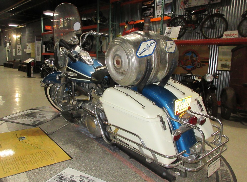 Blue Harley-Davidson Shovelhead with a beer keg mounted on the rear passenger seat
