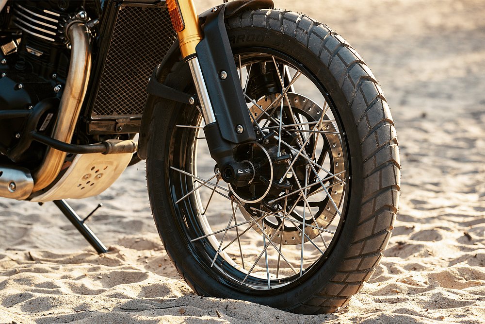 A close-up of the Scrambler 400 XC's front wheel.