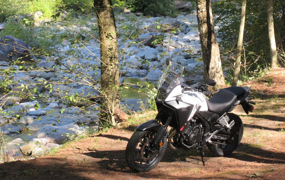 NX500 parked by a shady, rocky country stream
