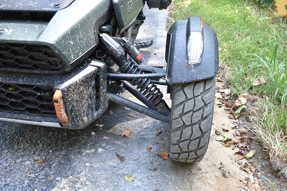 close view of the front suspension and wheel with rough-treaded tire