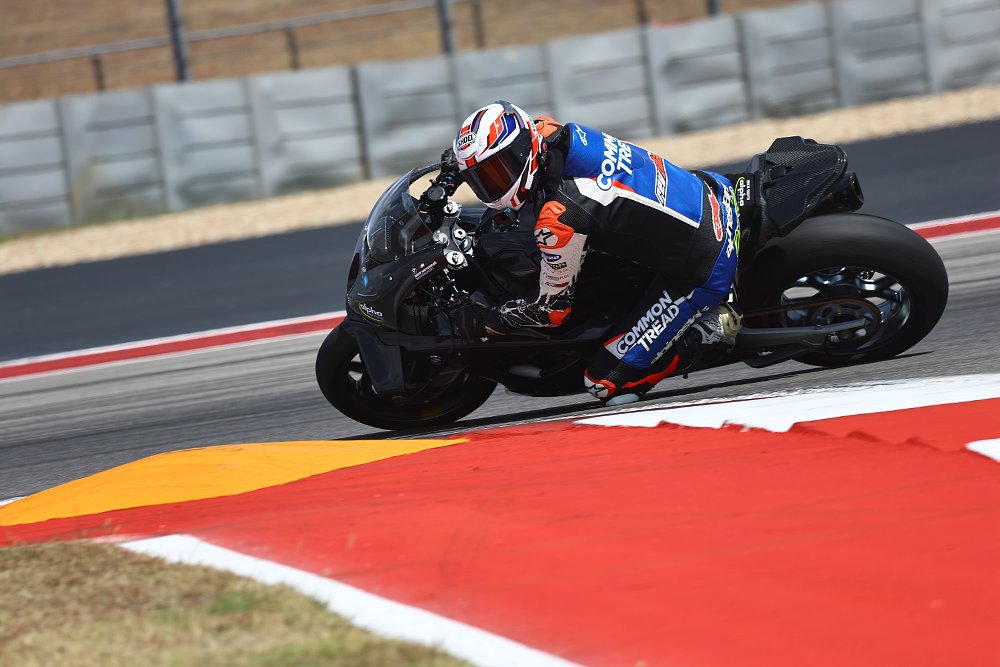 A 2025 alpha Racing M 1000 RR navigates Turn 11 at Circuit of the Americas in Austin, Texas.